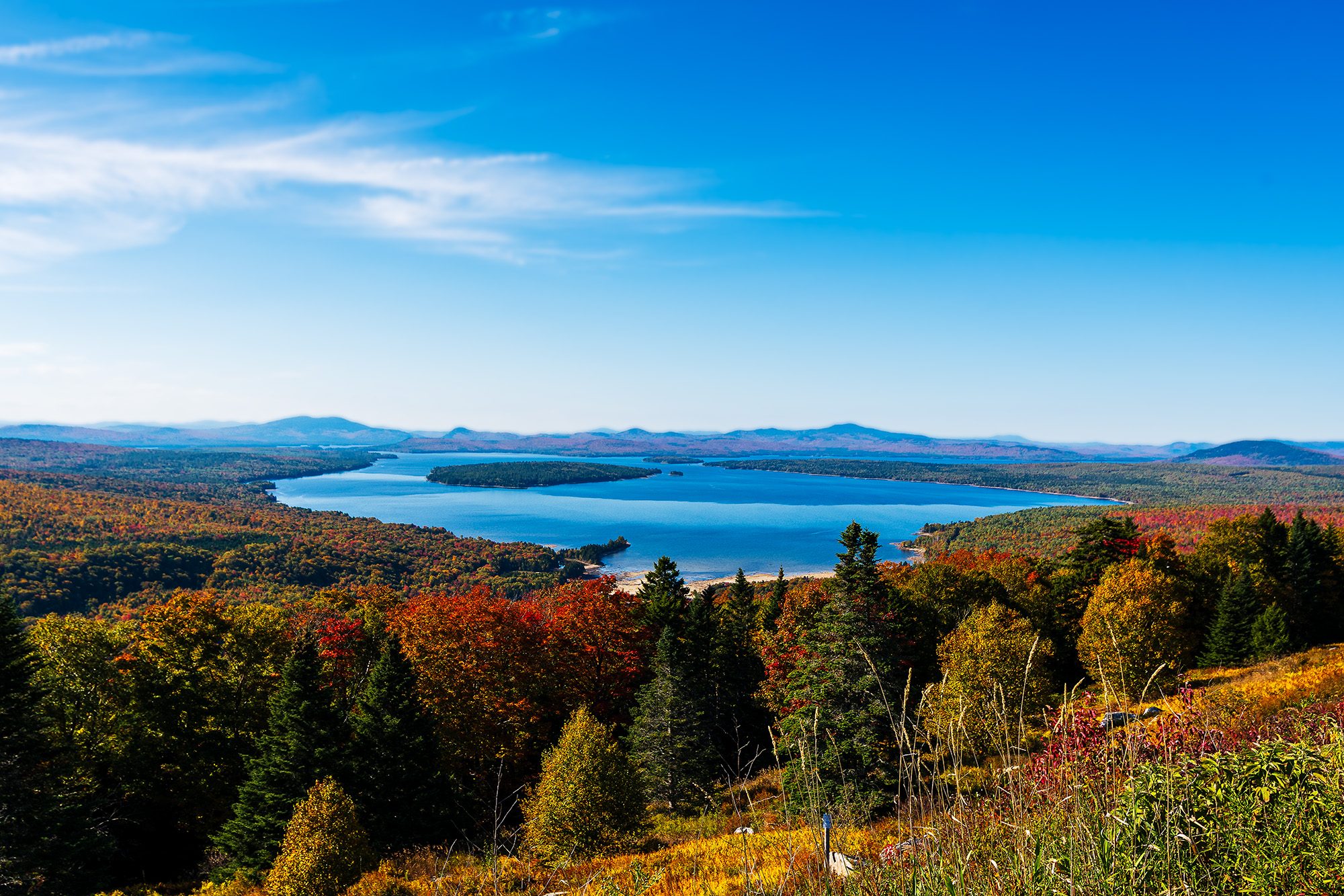 Overlook view from Height of Land in Western Maine with Mooselookmeguntic Lake and surrounding fall foliage.